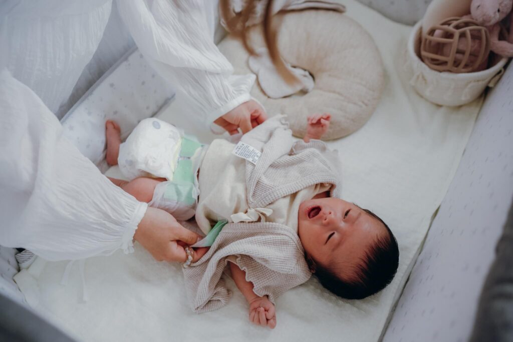 流山での自宅ニューボーンフォト｜生後まもない赤ちゃんのおむつ替えをする家族の自然な日常シーン